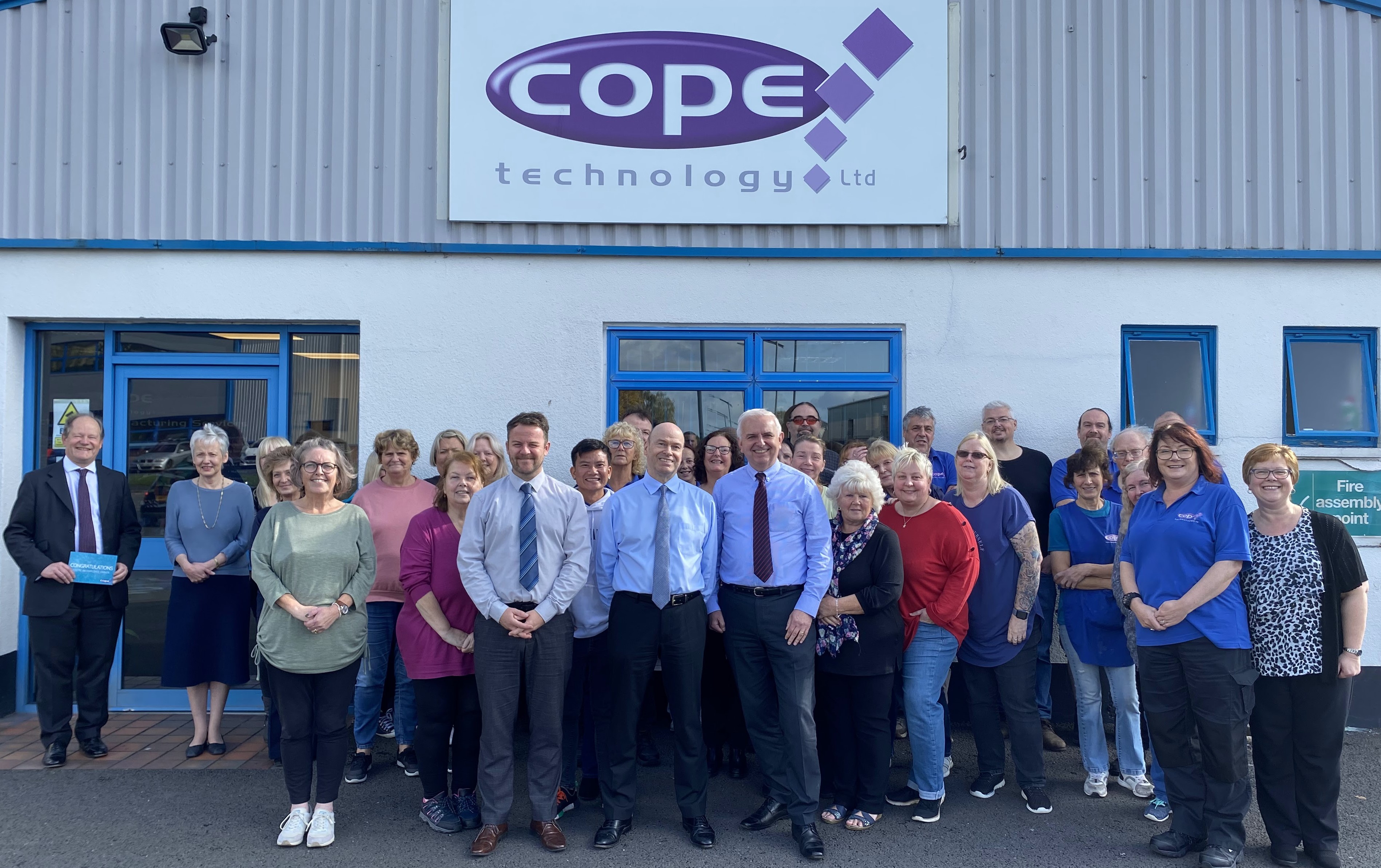 The Cope Technology employee-owned team outside the company building